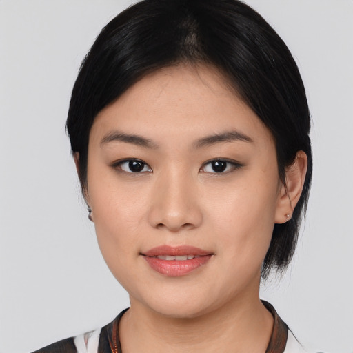 Joyful asian young-adult female with medium  black hair and brown eyes