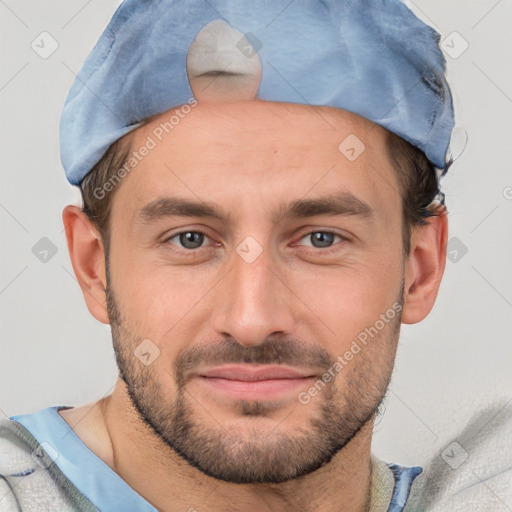 Joyful white adult male with short  brown hair and brown eyes