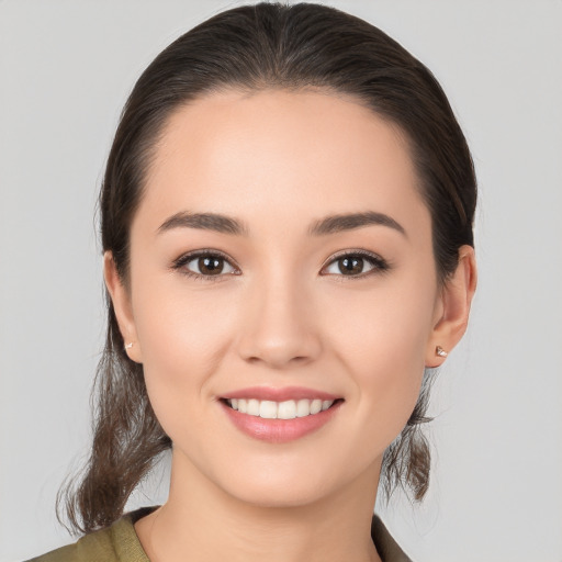 Joyful white young-adult female with medium  brown hair and brown eyes