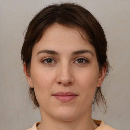 Joyful white young-adult female with medium  brown hair and brown eyes