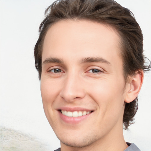 Joyful white young-adult male with medium  brown hair and brown eyes