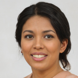 Joyful latino young-adult female with medium  brown hair and brown eyes