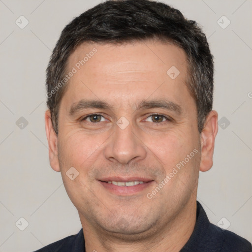 Joyful white adult male with short  brown hair and brown eyes