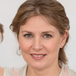 Joyful white adult female with medium  brown hair and blue eyes