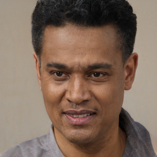 Joyful latino adult male with short  black hair and brown eyes
