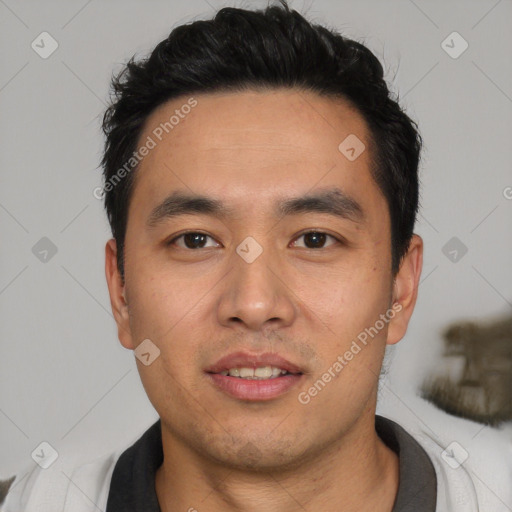 Joyful white young-adult male with short  black hair and brown eyes