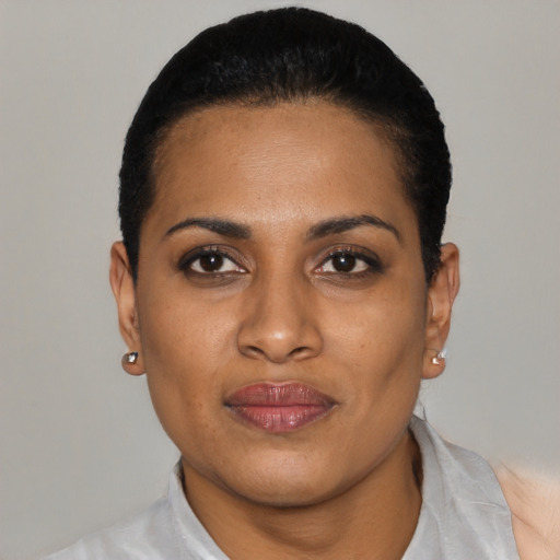 Joyful latino young-adult female with short  black hair and brown eyes