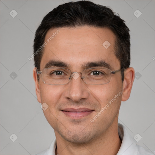 Joyful white adult male with short  black hair and brown eyes