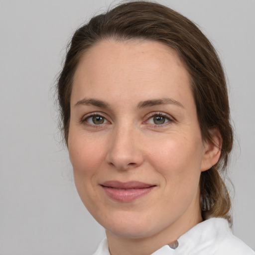 Joyful white adult female with medium  brown hair and brown eyes