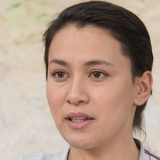 Joyful white adult female with medium  brown hair and brown eyes