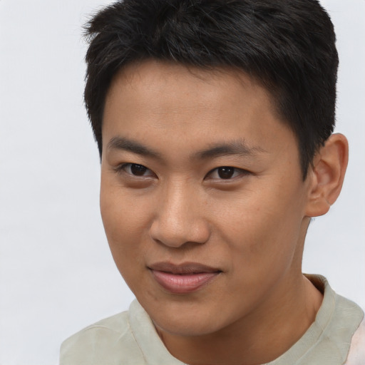 Joyful asian young-adult male with short  brown hair and brown eyes