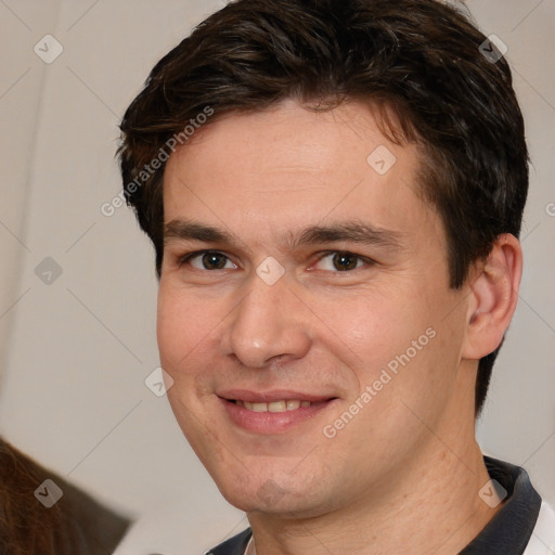 Joyful white adult male with short  brown hair and brown eyes