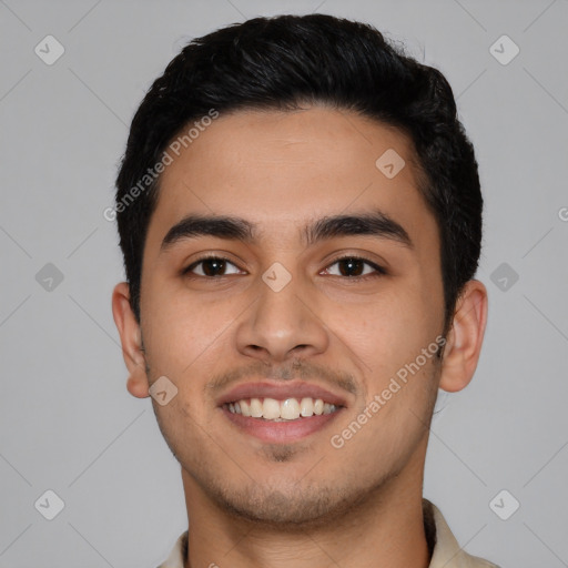 Joyful latino young-adult male with short  black hair and brown eyes