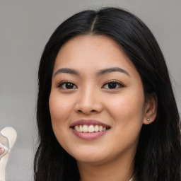 Joyful asian young-adult female with long  black hair and brown eyes