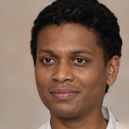 Joyful black young-adult male with short  black hair and brown eyes