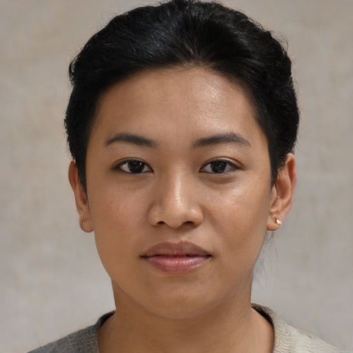 Joyful asian young-adult female with short  black hair and brown eyes