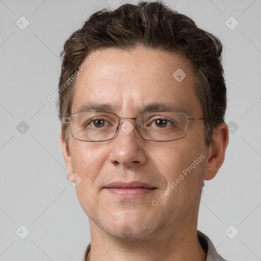 Joyful white adult male with short  brown hair and grey eyes