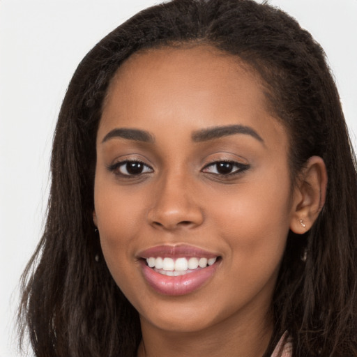 Joyful latino young-adult female with long  brown hair and brown eyes