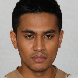 Neutral latino young-adult male with short  brown hair and brown eyes
