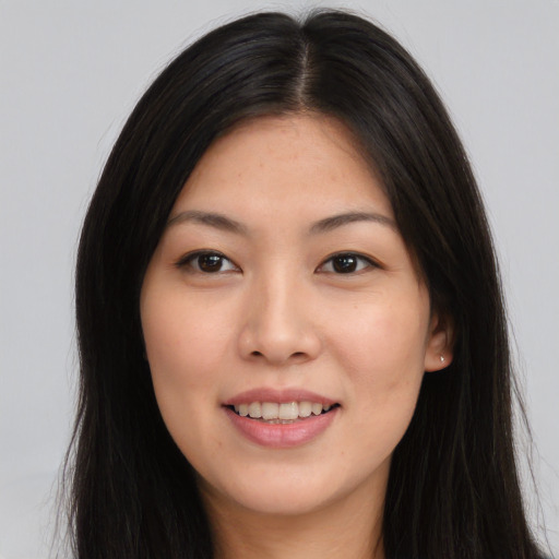 Joyful asian young-adult female with long  brown hair and brown eyes
