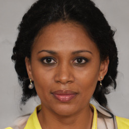 Joyful black adult female with medium  brown hair and brown eyes