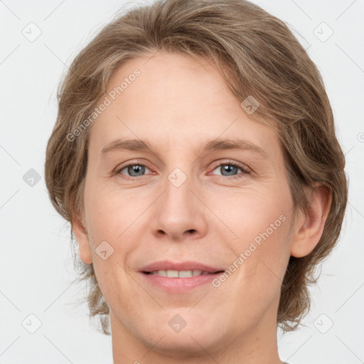 Joyful white adult female with medium  brown hair and grey eyes