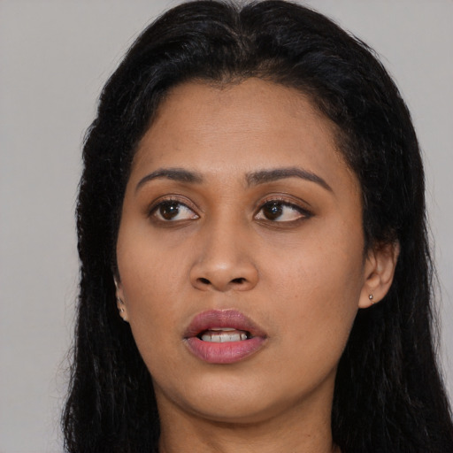 Joyful asian young-adult female with long  black hair and brown eyes