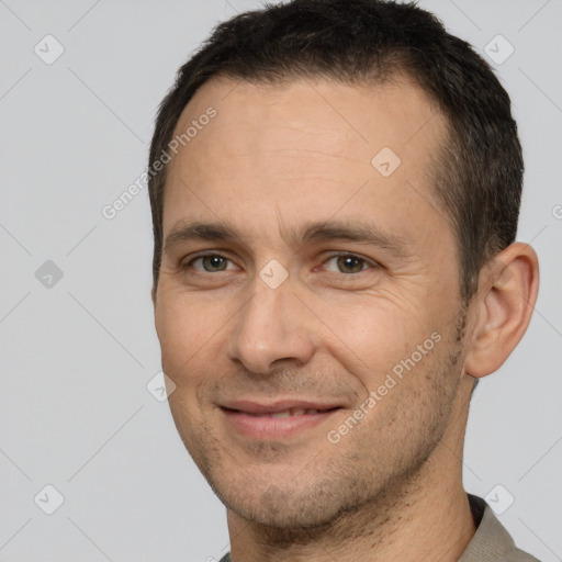 Joyful white adult male with short  brown hair and brown eyes