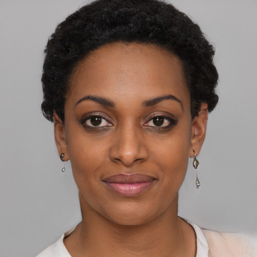 Joyful black young-adult female with short  black hair and brown eyes
