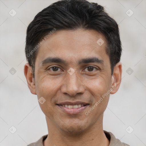 Joyful asian young-adult male with short  black hair and brown eyes