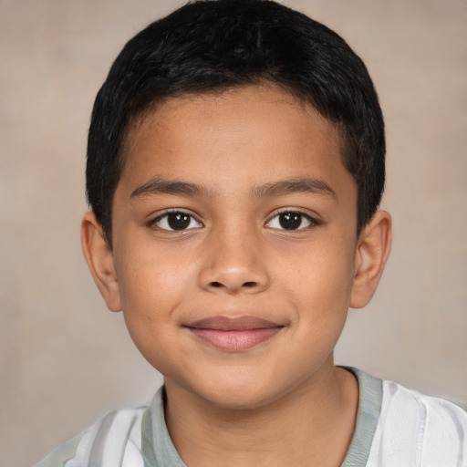 Joyful latino child male with short  brown hair and brown eyes