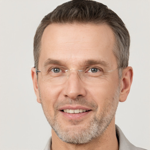 Joyful white adult male with short  brown hair and brown eyes