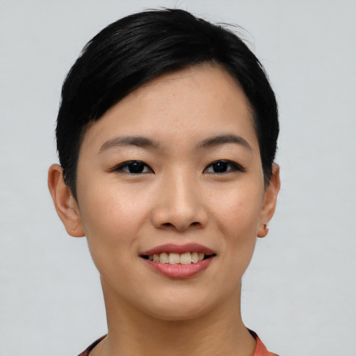 Joyful asian young-adult female with short  black hair and brown eyes