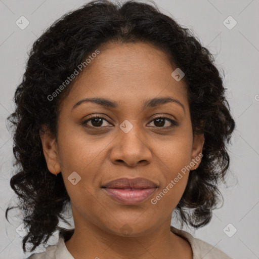 Joyful black adult female with medium  brown hair and brown eyes