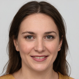 Joyful white young-adult female with medium  brown hair and grey eyes