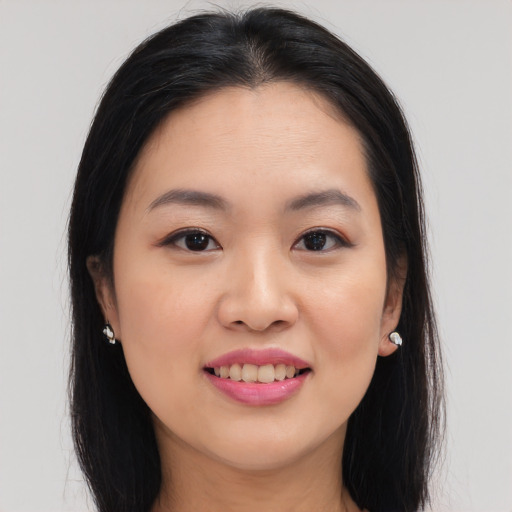 Joyful asian young-adult female with long  brown hair and brown eyes