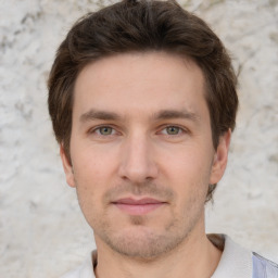 Joyful white young-adult male with short  brown hair and grey eyes