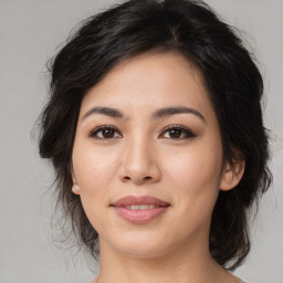 Joyful asian young-adult female with medium  brown hair and brown eyes