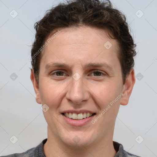 Joyful white adult male with short  brown hair and grey eyes