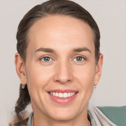 Joyful white adult female with short  brown hair and grey eyes