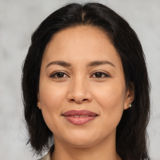 Joyful asian adult female with medium  brown hair and brown eyes