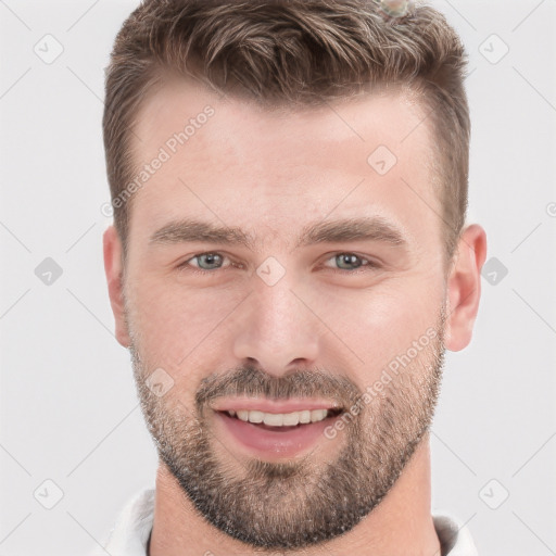 Joyful white young-adult male with short  brown hair and grey eyes