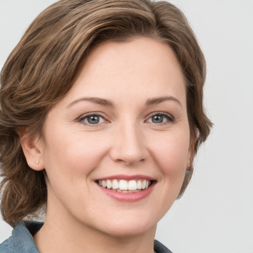 Joyful white young-adult female with medium  brown hair and blue eyes