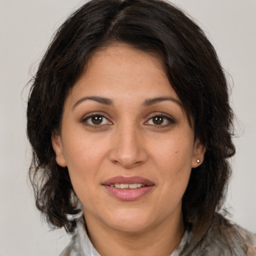 Joyful white adult female with medium  brown hair and brown eyes