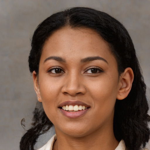 Joyful latino young-adult female with short  black hair and brown eyes