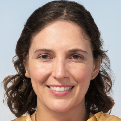 Joyful white adult female with medium  brown hair and brown eyes