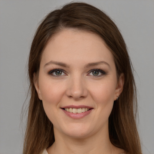 Joyful white young-adult female with long  brown hair and grey eyes