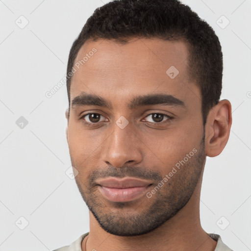 Joyful black young-adult male with short  brown hair and brown eyes