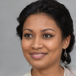 Joyful black young-adult female with medium  brown hair and brown eyes