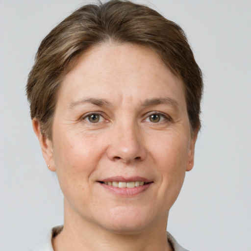 Joyful white adult female with short  brown hair and grey eyes